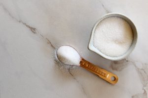 Small Bowl & Measuring Spoon Filled with Granules of Low-Calorie Sugar Allulose | Vitacost.com/blog