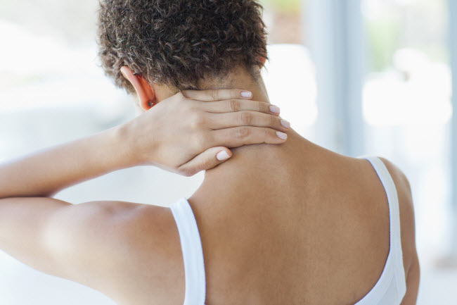 Back View of Short-Haired Woman Wondering What is Fascia Rubbing Painful Spot in Neck | Vitacost.com/blog