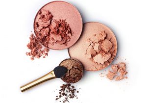 Overhead View of Various Color Cosmetic Powders in Tins with Blush Brush Exemplifying Skin Care Ingredients to Avoid | Vitacost.com/blog