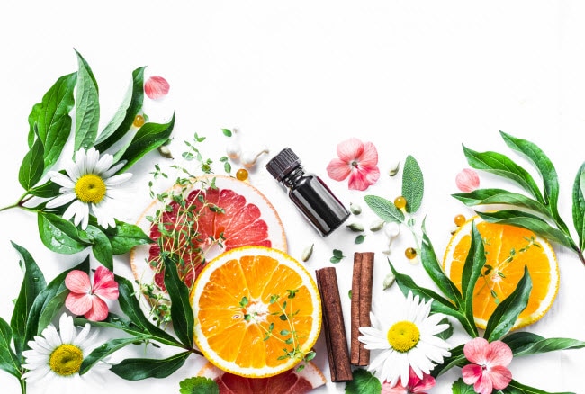 9 Essential Oils and Uses for Spring Concept of Essential Oils and Uses Demonstrated by Citrus Fruit, Spring Flowers, Leaves and Amber Bottle | Vitacost.com/blog