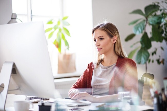 Woman in Office Purifying Air with Desk Plants | Vitacost.com/Blog
