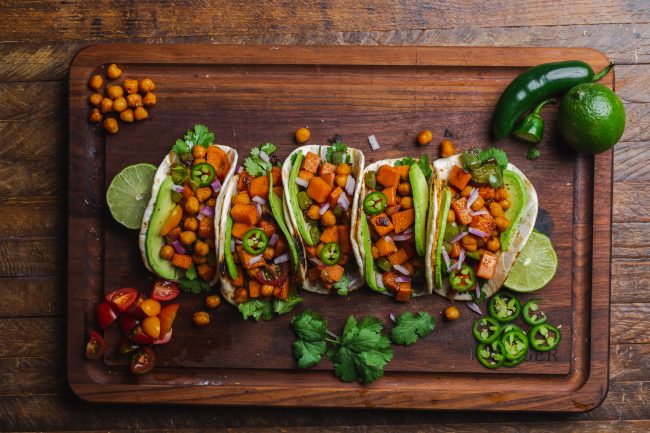Spicy Vegan Tacos with Sweet Potatoes & Chickpeas  Chickpea and Sweet Potato Vegan Tacos on Large Wood Cutting Board | Vitacost.com/blog