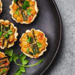 Vegetable Mini Tarts on Black Plate | Vitacost Blog