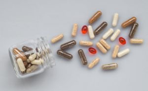 Question of What are Minerals Answered by Glass Jar Turned on Side with Supplements Spilling Out | Vitacost.com/blog