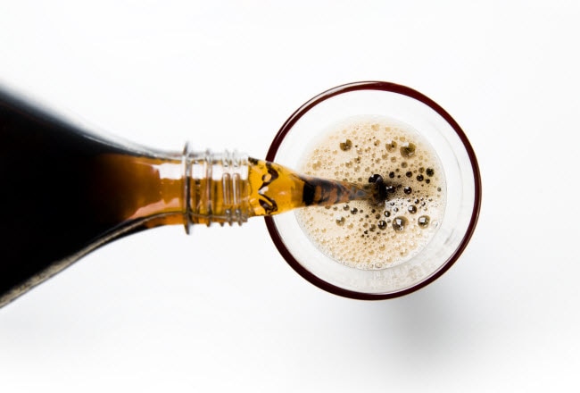 Overhead View of Soda Bottle Pouring into Glass to Represent Question Is High Fructose Corn Syrup Bad for You | Vitacost.com/blog