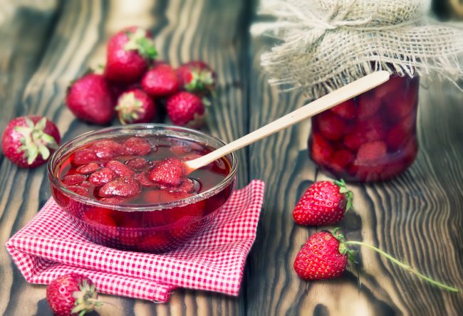 Probiotic-Rich Fermented Berries Bowl of Fermented Strawberries with Wooden Spoon | Vitacost Blog