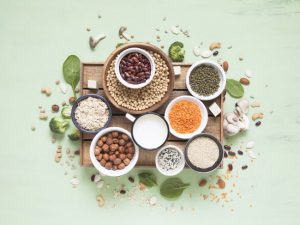 Arrangement of Various Foods High in Lectins on Wooden Board on Pale Green Surface | Vitacost.com/blog
