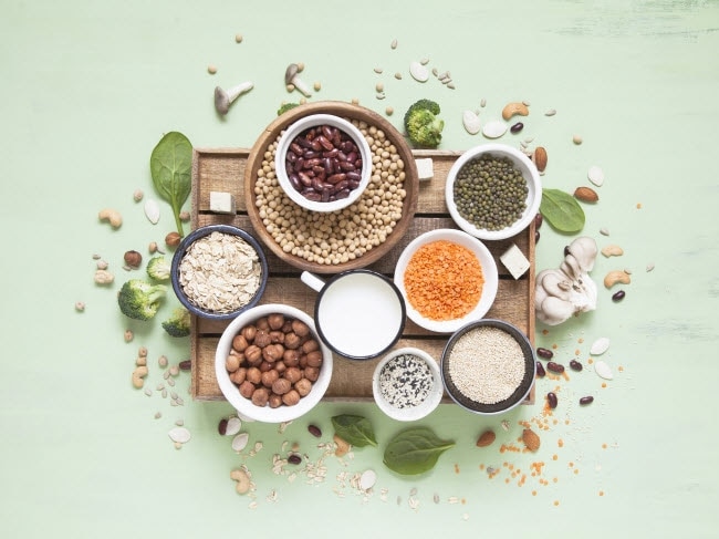 Arrangement of Various Foods High in Lectins on Wooden Board on Pale Green Surface | Vitacost.com/blog