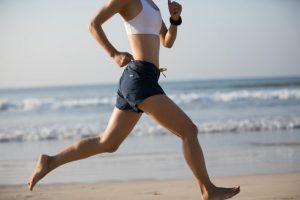 Fit Woman on Beach Enjoying the Benefits of Barefoot Running | Vitacost.com/blog