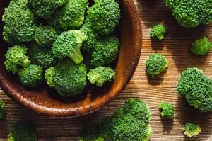 Broccoli Florets in Wooden Bowl on Wooden Table to Represent Estrogen Boosting Foods | Vitacost.com/blog