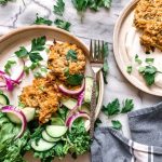 Chickpea Fritters with Cucumber and Onion Salad On White Granite | Vitacost Blog
