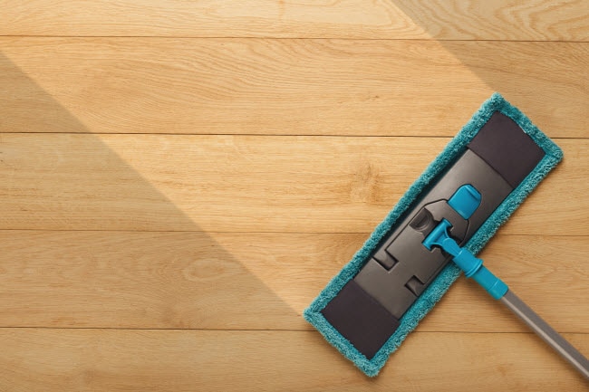 Overhead View of Mop Swiping Wood Floor to Represent Tips on How to Clean Wood Floors Naturally | Vitacost.om/blog 