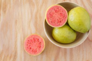 Guava Fruit in Bowl on Wooden Table as Example of Foods That are Good for Your Skin | Vitcost.com/blog