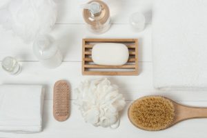 Various Natural Shower Products Laid Out on White Wooden Bath and Beauty Surface | Vitacost.com/blog