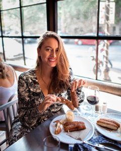 Food Blogger Anastasia Keramidas Eating Bread at a Restaurant | Vitacost.com/Blog