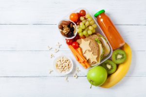 How to Pack Lunch for School Exemplified by Healthful Foods Options with Fruit in Juice on White Wood Background | Vitacost.com/blog