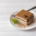 Tiramisu on White Plate Off-Centered on White Wooden Table | Vitacost Blog