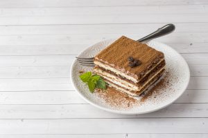 Tiramisu on White Plate Off-Centered on White Wooden Table | Vitacost Blog