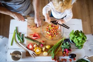Overhead View of Dad Cooking with Child Following Tips for Reducing Sugar in Kids' Diets | Vitacost.com/blog