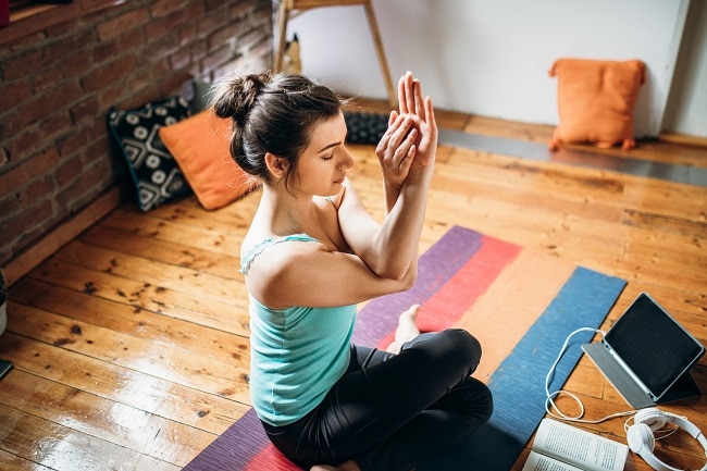 Woman Practicing Yoga at Home Listening to Music | Vitacost.com/Blog