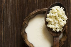 Milk kefir grains on a wooden spoon overhead shot