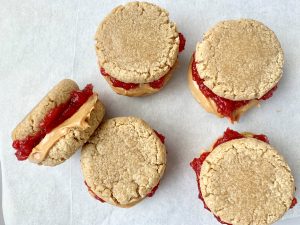 Peanut butter and jelly sandwiched between two cookies