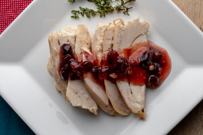 Sliced Turkey With Cranberry Sauce on White Plate as Example of How to Diet on Thanksgiving When Following Keto Diet Tips | Vitacost.com/blog
