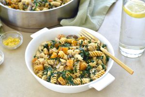 Butternut squash pasta salad in bowl with fork