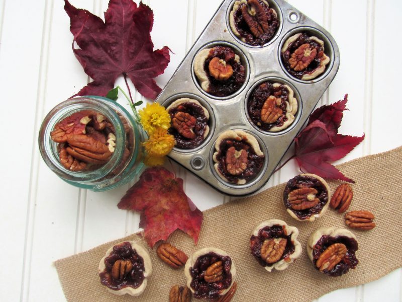 Top View of Pecan Tarts in Muffin Tin Surrounded by Autumn Leaves | Vitacost Blog