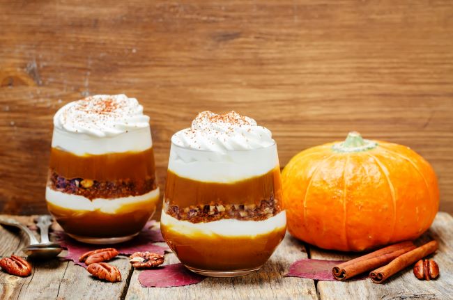 Two Pumpkin Pie Parfaits in Glass Jars Next to Small Pumpkin | Vitacost.com/blog