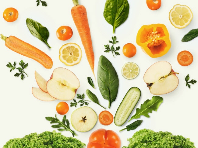 Artistic Display of Fruits and Vegetables on White Surface to Represent Concept of Using Food Scraps in Zero Waste Lifestyle | Vitacost Blog