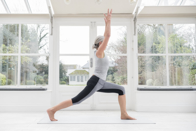 Side View of Woman in Workout Clothing Doing Lunges as Part of Best Exercises for Overall Health | Vitacost.com/blog