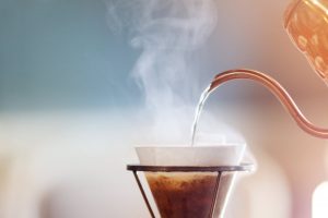 Steaming Hot Water Being Poured Into Coffee Filter to Represent Health Benefits of Coffee | Vitacost Blog