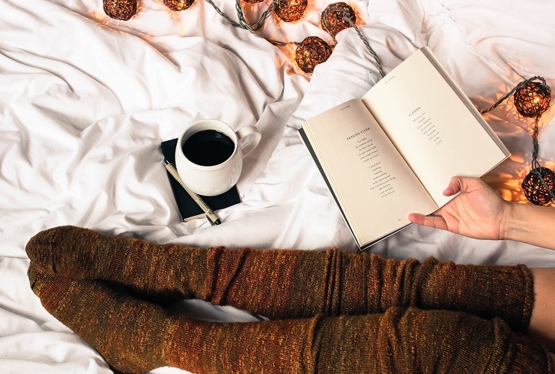 Person Reading Yoga Book in Bed | Vitacost.com/Blog