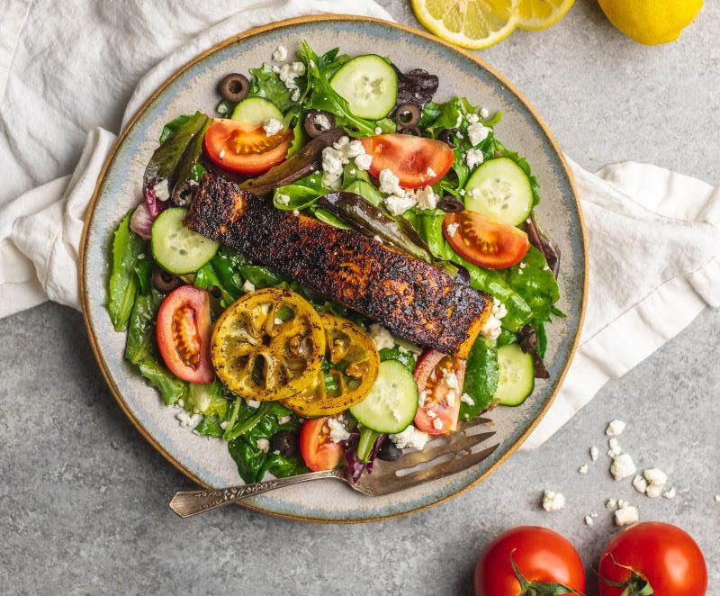 Mediterranean meal: salmon fillet atop colorful salad