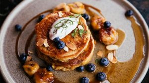 Gluten-free and vegan blueberry pancakes with carmelized bananas