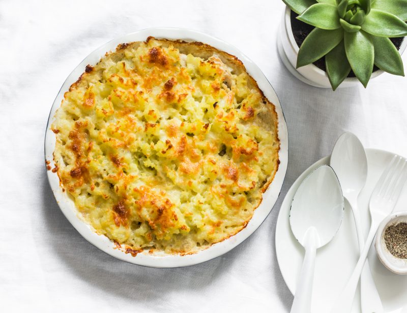 Top View of Shepherd's Pie on White Table with White Plate and Silverware | Vitacost Blog
