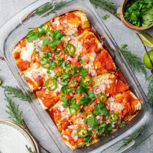 Top View of Dish of Enchiladas Topped with Red Sauce, Jalapenos and Cilantro | Vitacost Blog