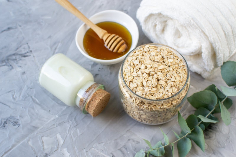 Examples of How to Exfoliate Including Oatmeal, Sea Salt and Honey on Gray Marble Surface | Vitacost.com/blog