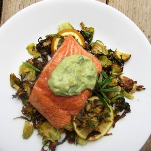 Salmon Topped with Green SAuce Over Brussels Sprouts on White Plate | Vitacost Blog