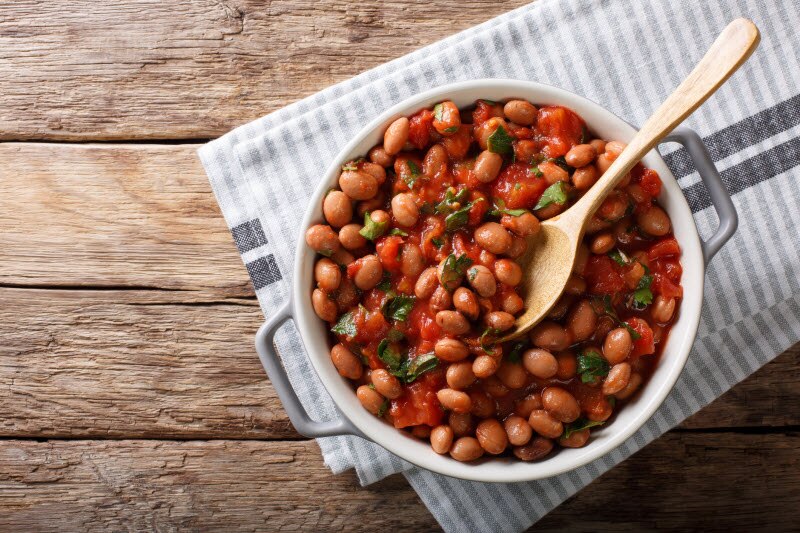 Bowl of Bean Chili on Striped Cloth on Wood Table to Represent Nutrition Benefits of Beans | Vitacost.com/blog