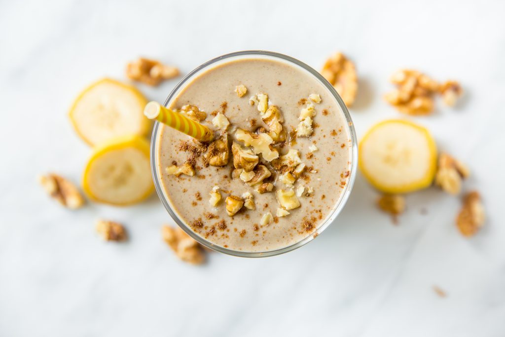 Top View of Banana Smoothie Garnished with Walnuts | Vitacost Blog