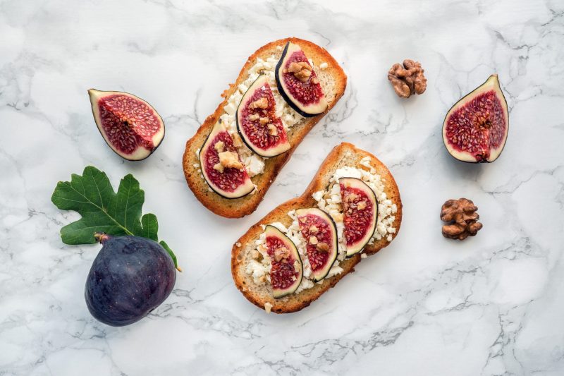 Fig Toast Two Slices of Toast Topped with Cheese, Figs and Walnuts Over Marble | Vitacost Blog
