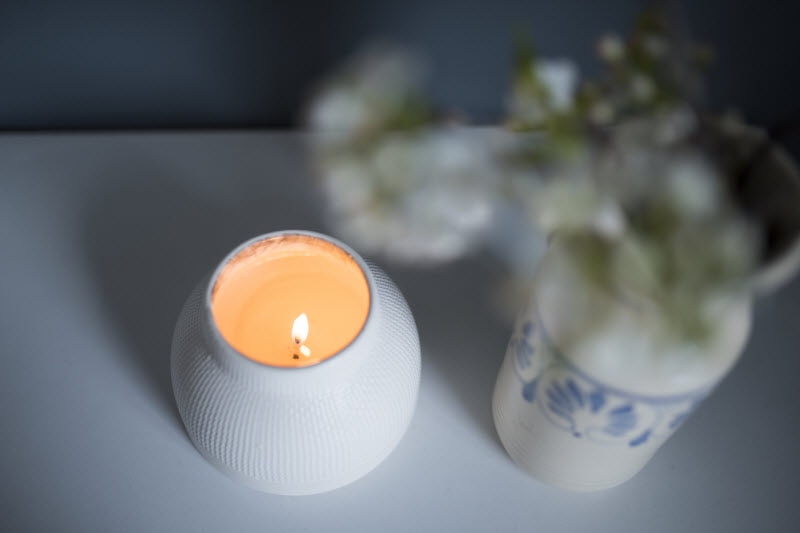 Dim Setting with Glowing Natural Home Candles & Vases With Greenery on White Table | Vitacost.com/blog
