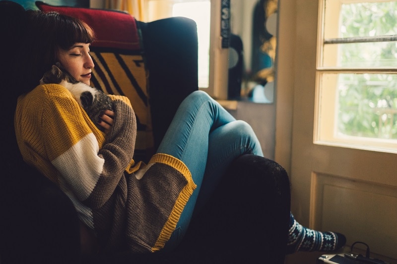 Woman Cuddling with Cat While Sheltering in Place During Coronavirus Pandemic | Vitacost.com/Blog