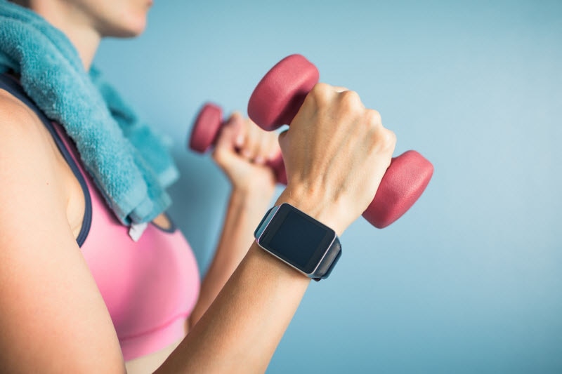 Concept of Exercise and Immune System Health Represented by Woman Lifting Small Weights in Workout Gear | Vitacost.com/blog