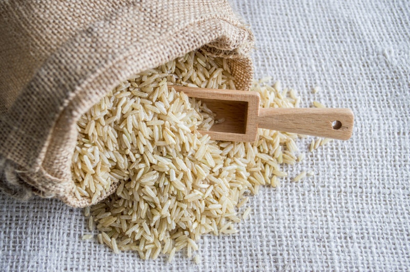 Burlap Sack of Rice Spilling Out with Wooden Scoop to Represent Concept Is Rice Healthy | Vitacost.com/blog