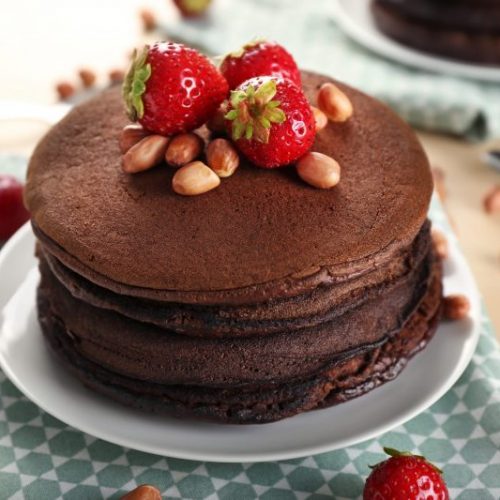 Stack of Dark Chocolate Pancakes Garnished with Strawberries and Nuts | Vitacost Blog