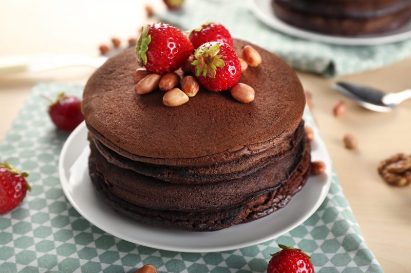 Stack of Dark Chocolate Pancakes Garnished with Strawberries and Nuts | Vitacost Blog