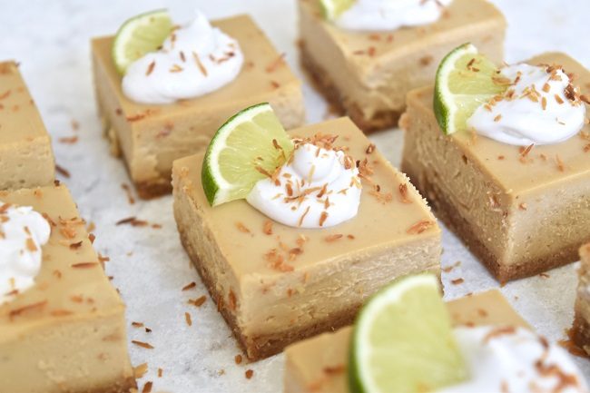 Close Up of Key Lime Pie Bars with Whipped Cream and Lime Garnish | Vitacost Blog